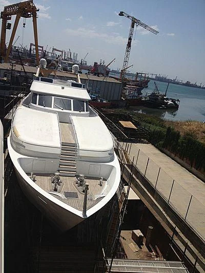 a boat docked at a pier aboard LIMITLESS Yacht for Sale