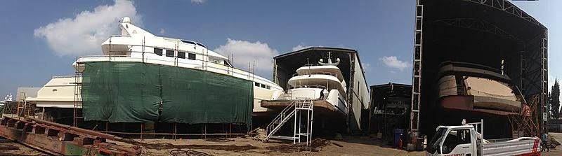 a large ship in a harbor aboard LIMITLESS Yacht for Sale