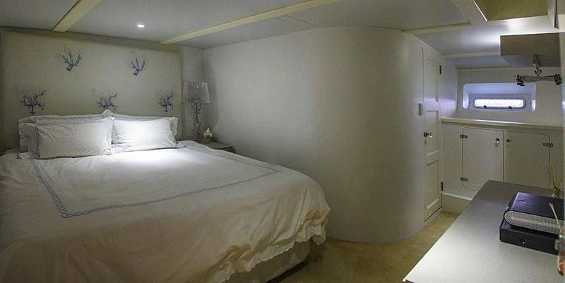 a room with a bed and a desk aboard FALCON Yacht for Sale