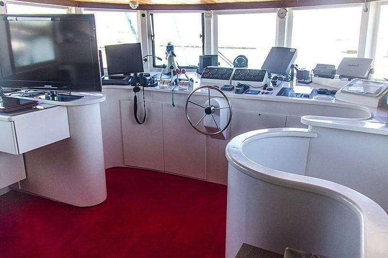 a room with a red carpet and white desks and a red carpet aboard FALCON Yacht for Sale