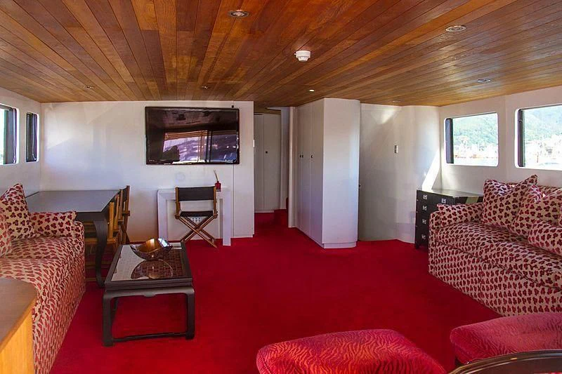 a living room with a red rug aboard FALCON Yacht for Sale