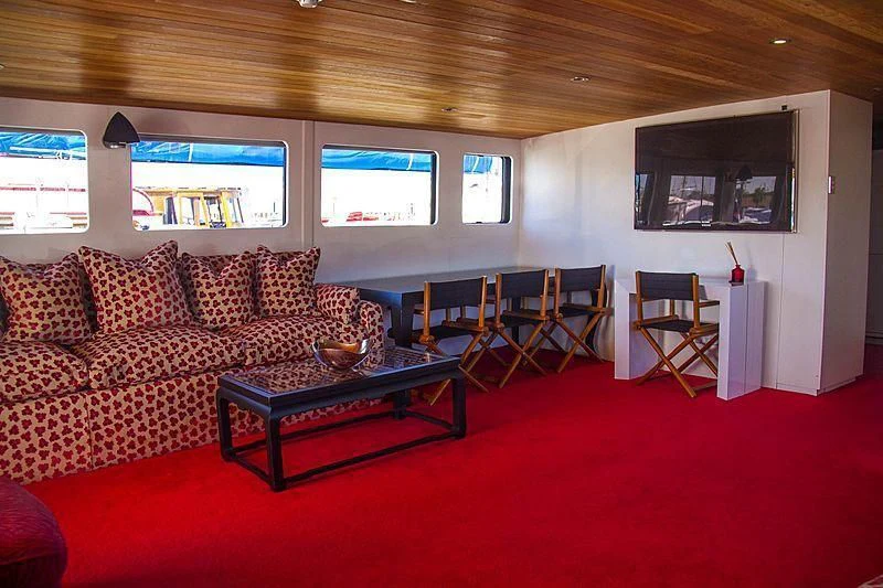 a living room with a red carpet aboard FALCON Yacht for Sale