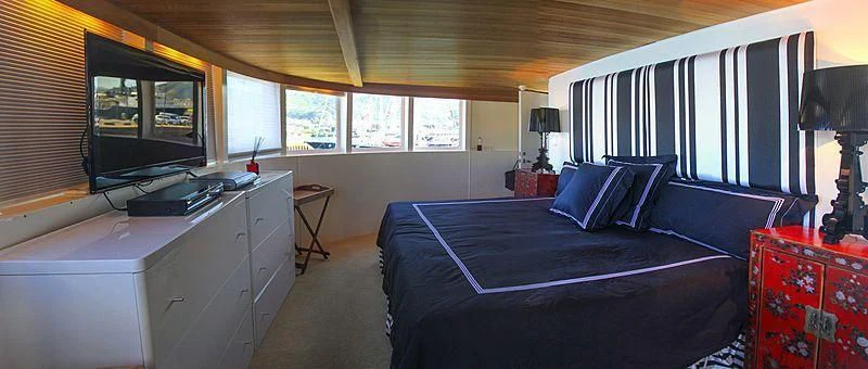 a bedroom with a bed and a desk aboard FALCON Yacht for Sale