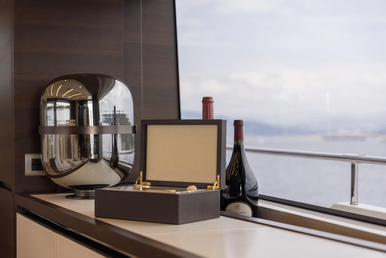 a wine bottle and a computer on a counter aboard ELLIE JAMES Yacht for Sale