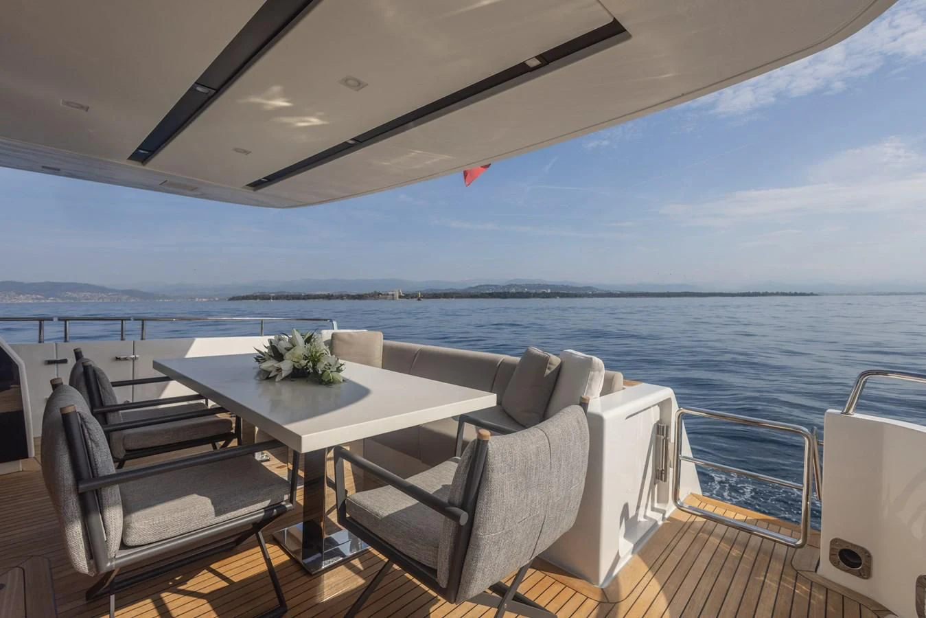 a table and chairs on a deck overlooking the ocean aboard ELLIE JAMES Yacht for Sale
