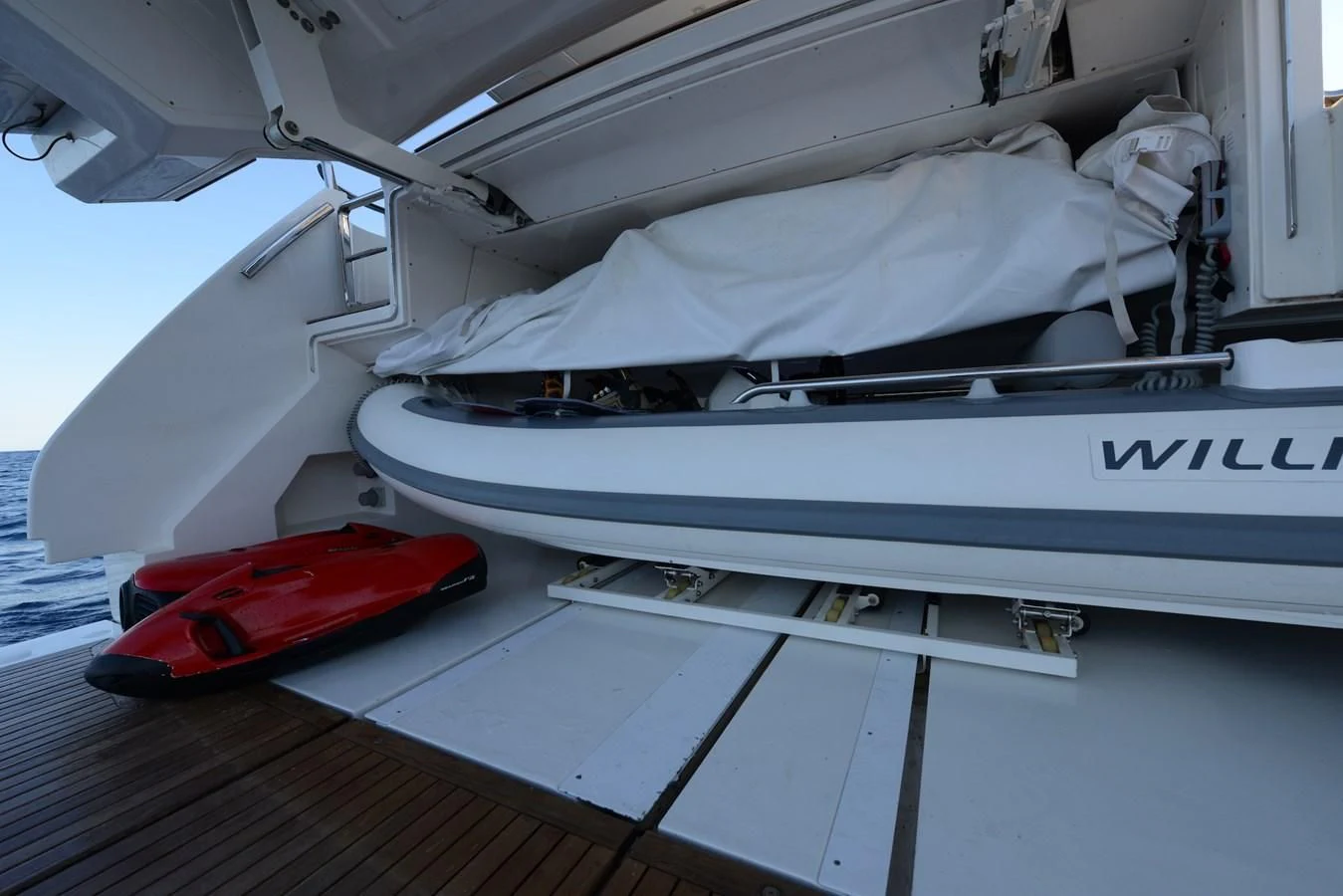 a white boat with a red object on the side aboard ELLIE JAMES Yacht for Sale