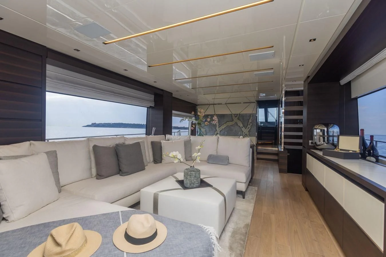 a modern living room with a large window aboard ELLIE JAMES Yacht for Sale