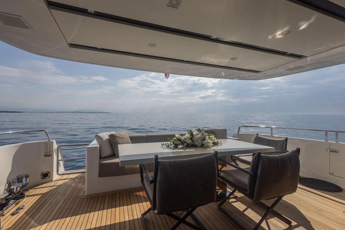 a table and chairs on a deck overlooking the ocean aboard ELLIE JAMES Yacht for Sale