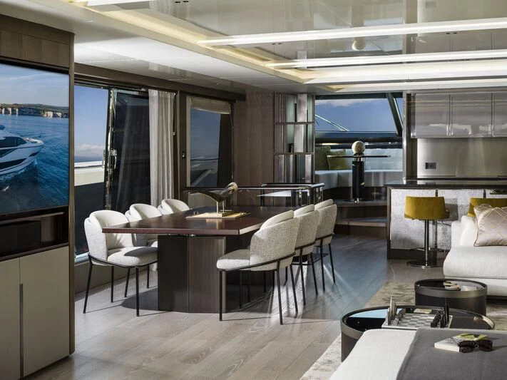 a room with a table chairs and a tv aboard BANDAZUL Yacht for Sale