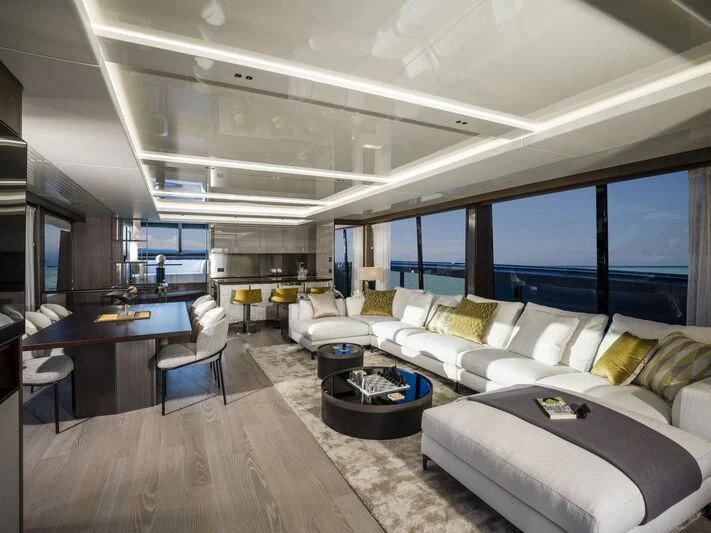 a room with a couch and a table and a large window aboard BANDAZUL Yacht for Sale