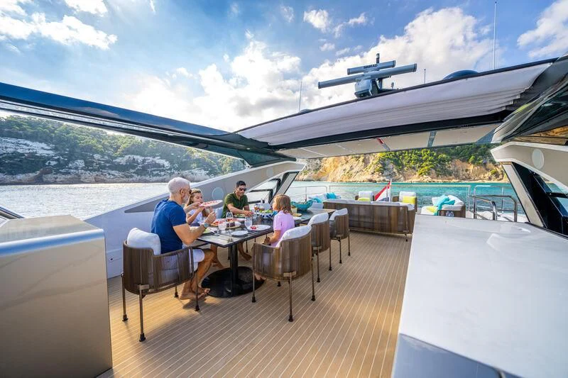 people sitting at a table outside aboard BANDAZUL Yacht for Sale