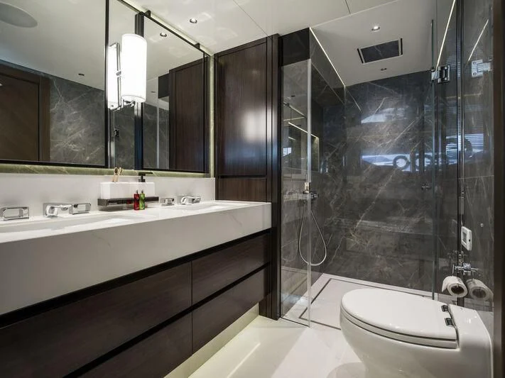 a bathroom with a glass shower aboard BANDAZUL Yacht for Sale