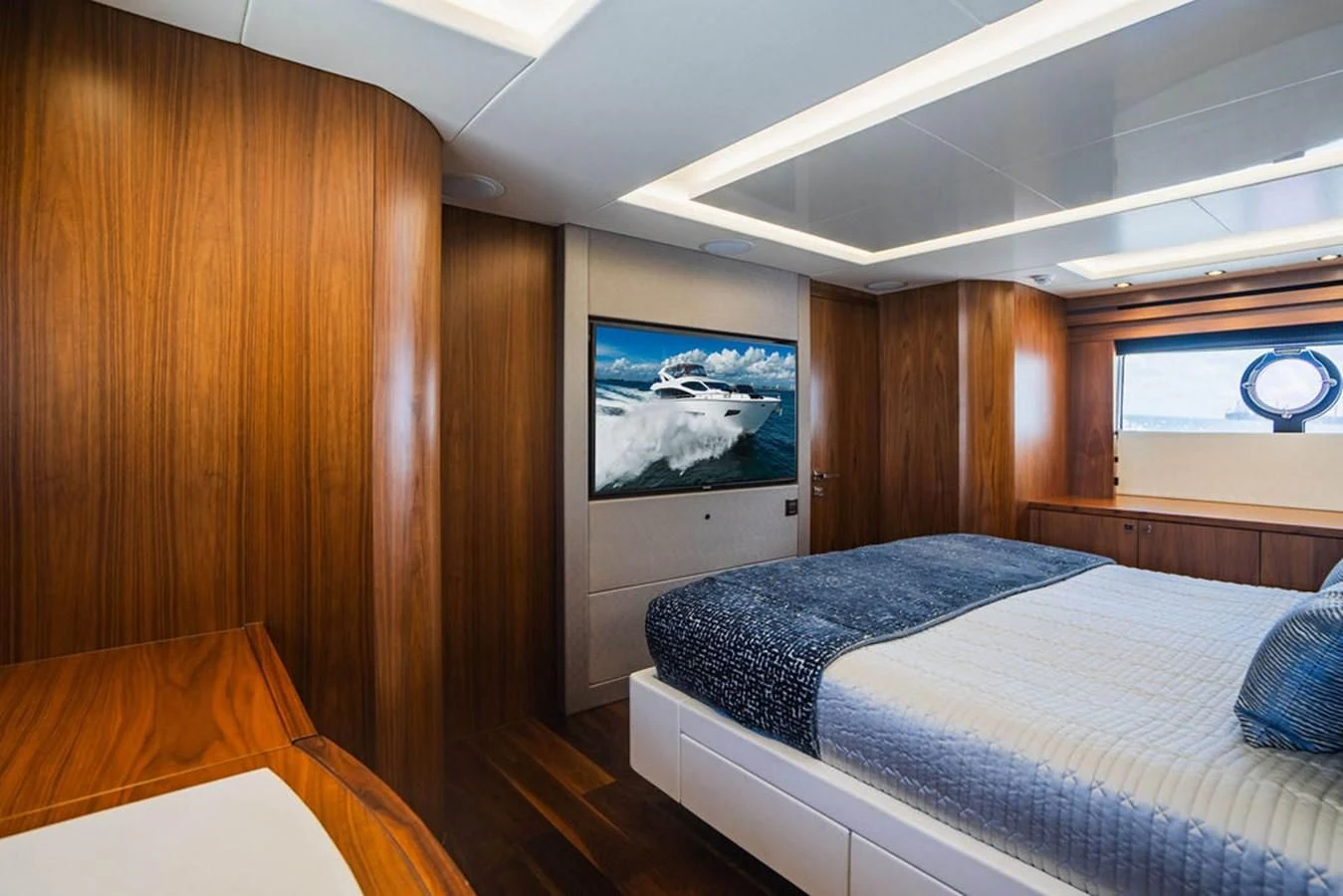 a bedroom with a bed and a painting on the wall aboard SEA-ZAR Yacht for Sale
