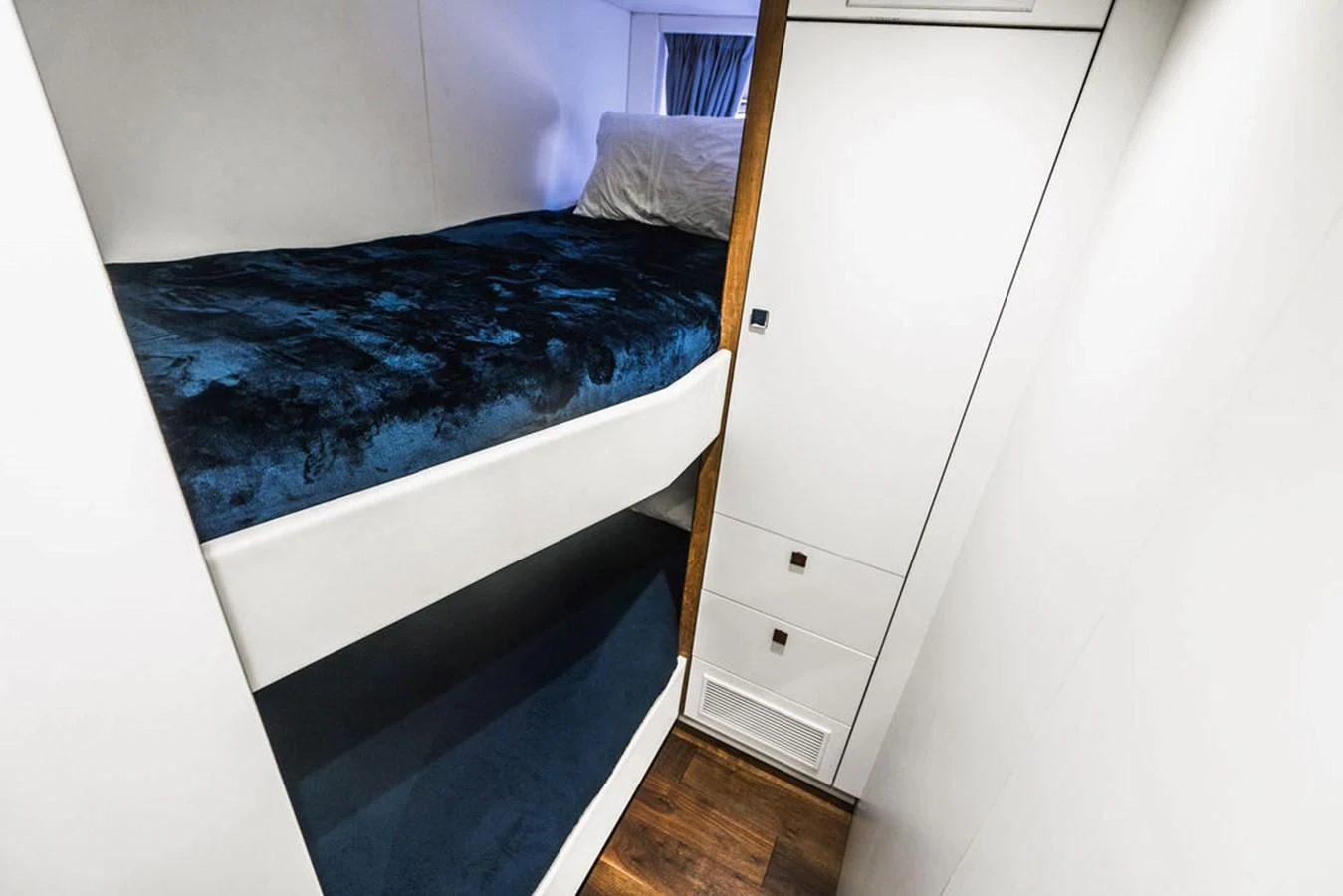 a bed with a blue blanket aboard SEA-ZAR Yacht for Sale