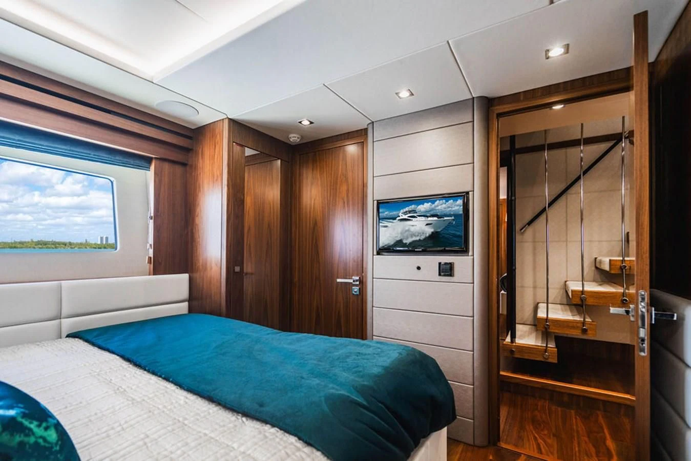 a bedroom with a bed and a glass door aboard SEA-ZAR Yacht for Sale