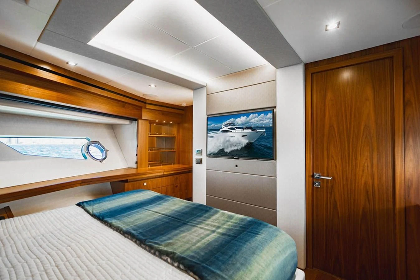 a bedroom with a bed and a wood door aboard SEA-ZAR Yacht for Sale