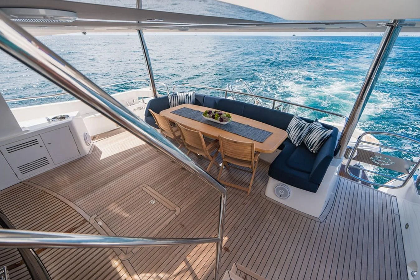 a deck with a table and chairs on it aboard SEA-ZAR Yacht for Sale