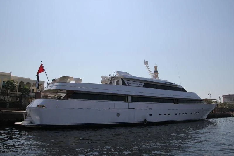 a large white boat on a body of water aboard AL FAHEDI Yacht for Sale