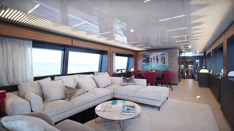 a living room with a couch and a table aboard JAVA Yacht for Sale