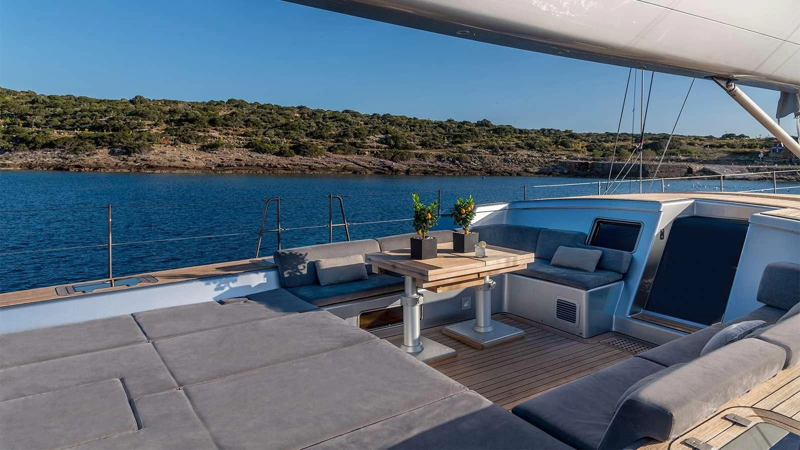 a deck with a table and chairs on it aboard BLACK LION Yacht for Sale