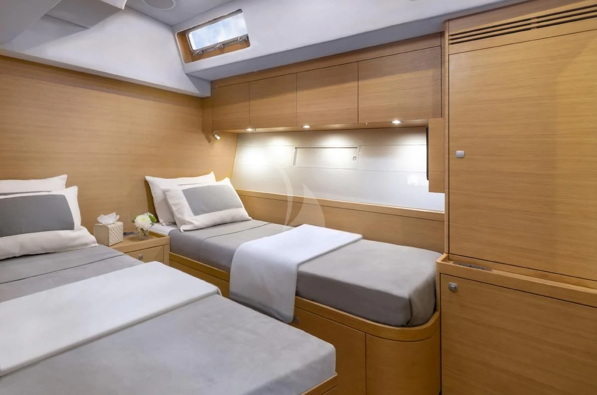 a room with beds and a cabinet aboard BLACK LION Yacht for Sale