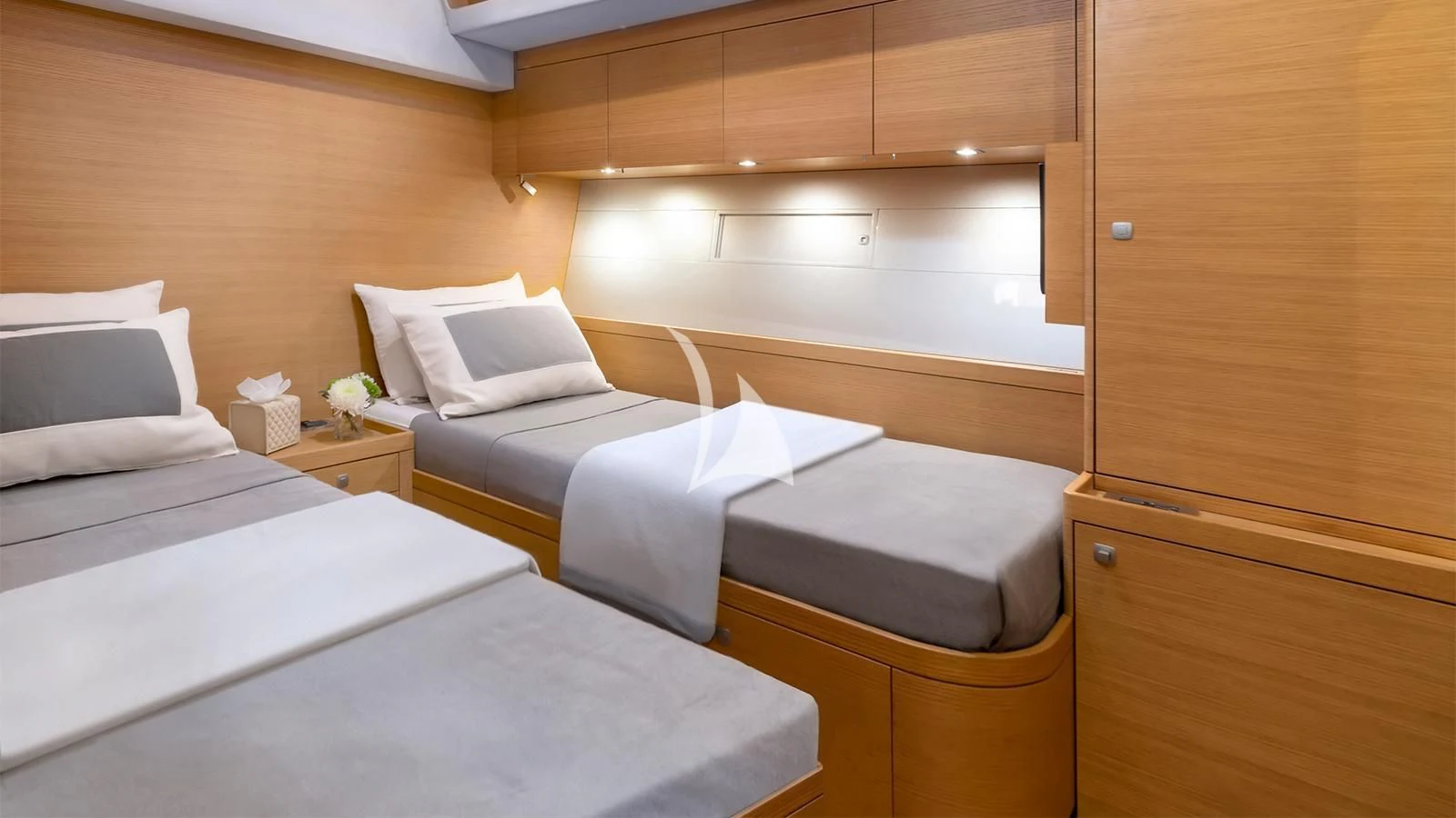 a room with beds and a cabinet aboard BLACK LION Yacht for Sale