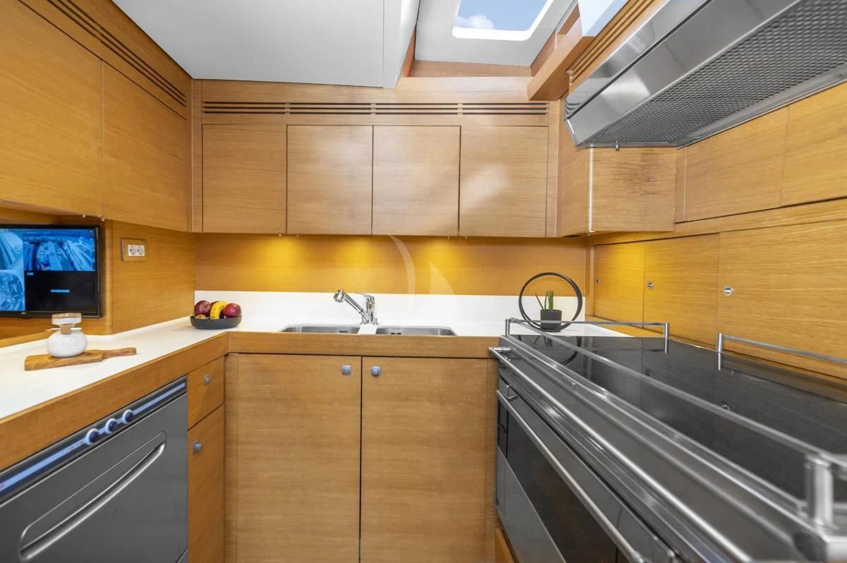 a kitchen with wooden cabinets aboard BLACK LION Yacht for Sale