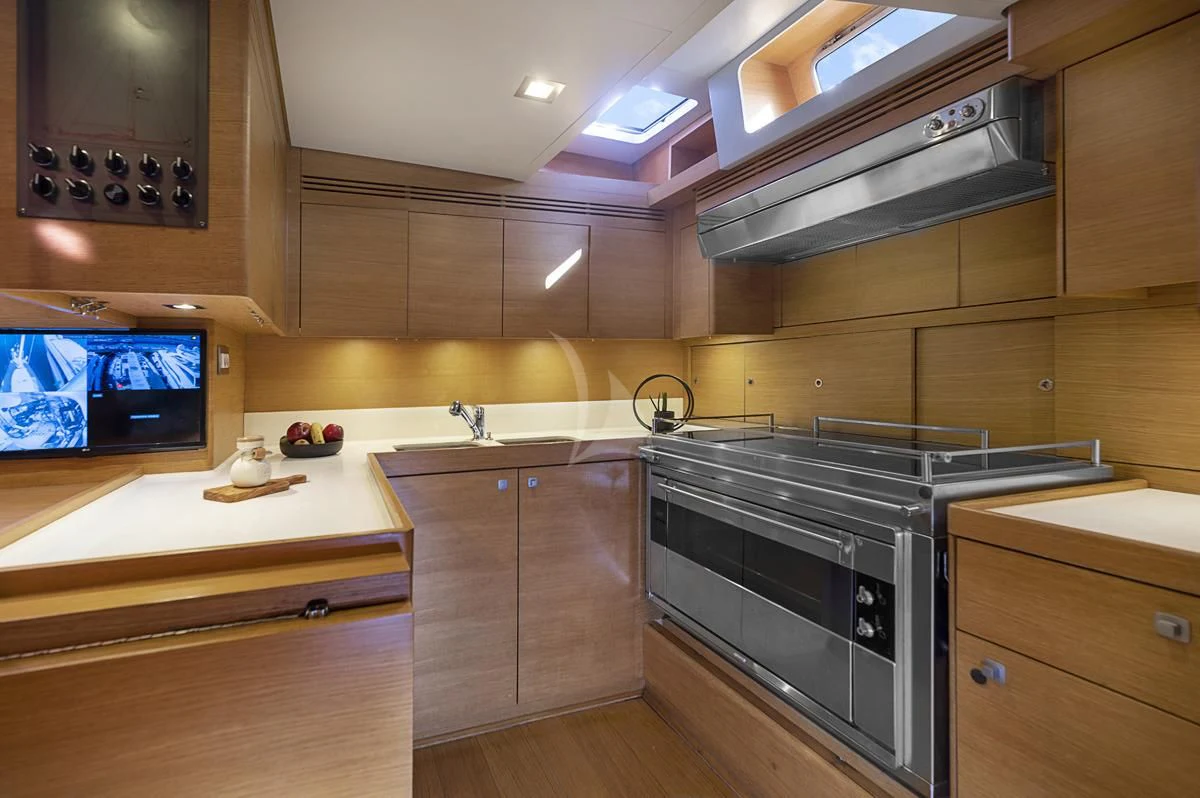 a kitchen with wooden cabinets aboard BLACK LION Yacht for Sale