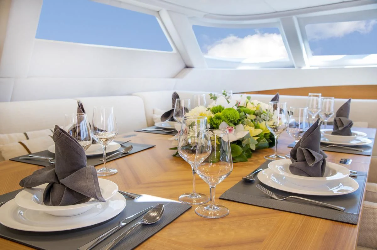 a table with plates and glasses aboard BLACK LION Yacht for Sale