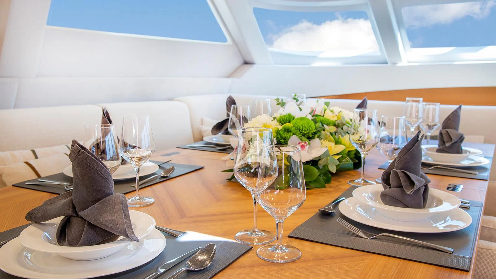 a table with plates and glasses aboard BLACK LION Yacht for Sale
