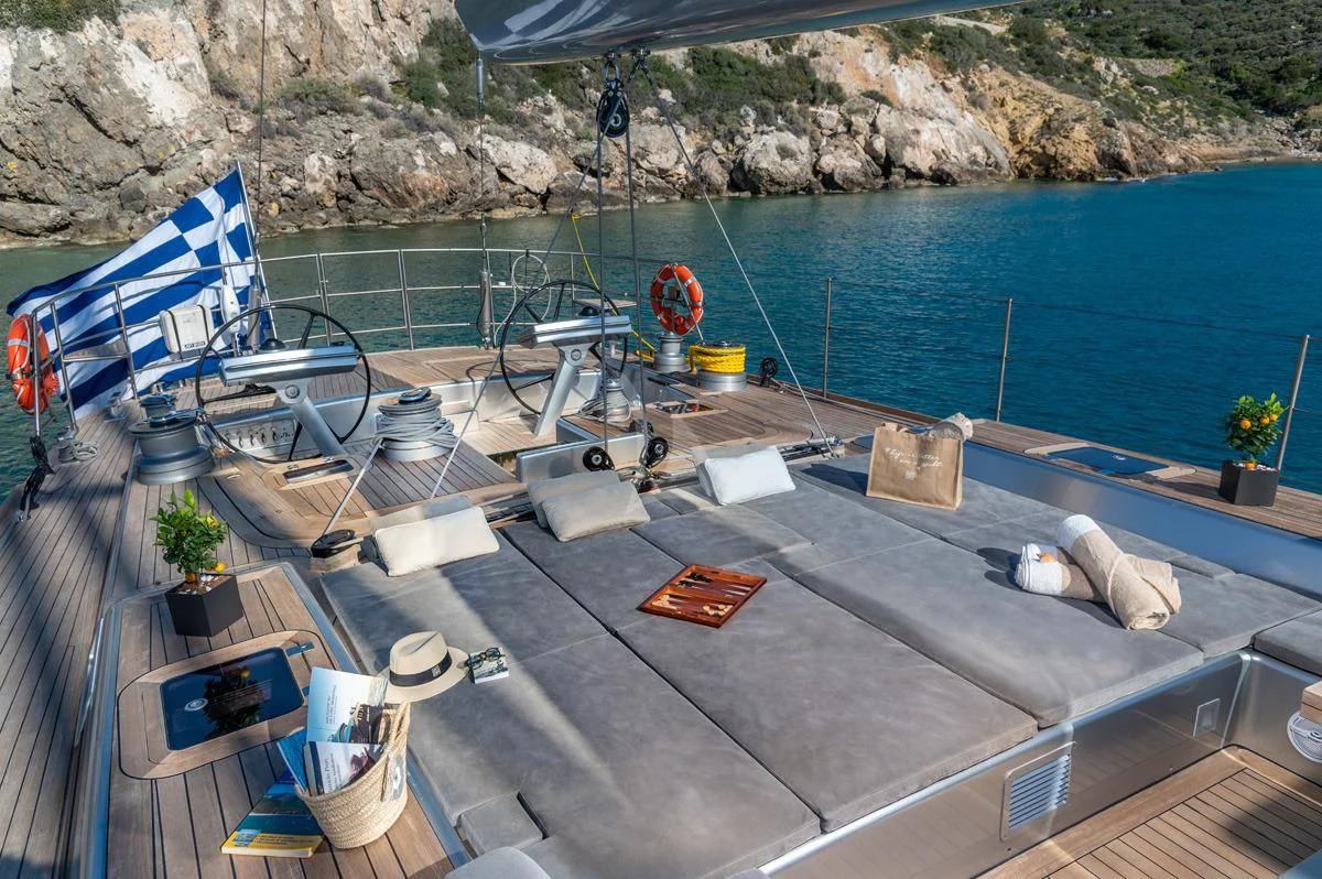 a deck with a boat and a chair on it aboard BLACK LION Yacht for Sale