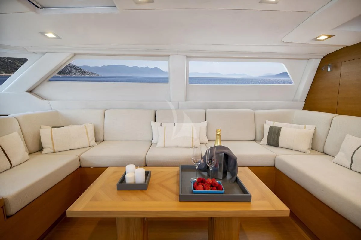 a living room with a couch and a table aboard BLACK LION Yacht for Sale