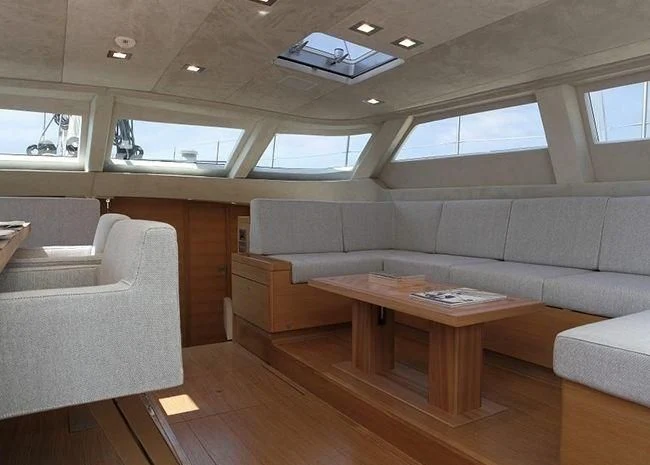 a living room with a couch and a coffee table aboard BLACK LION Yacht for Sale