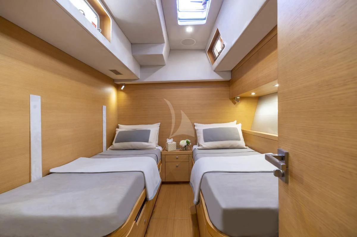 a room with beds and a wood door aboard BLACK LION Yacht for Sale