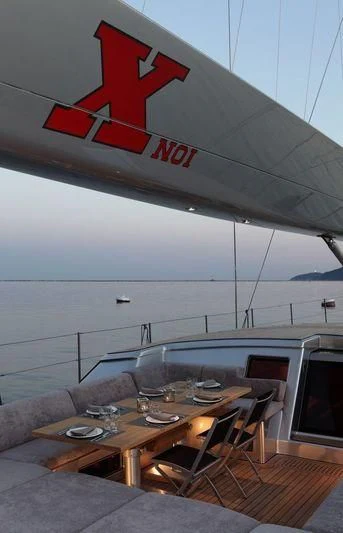 a table with chairs and a couch aboard BLACK LION Yacht for Sale