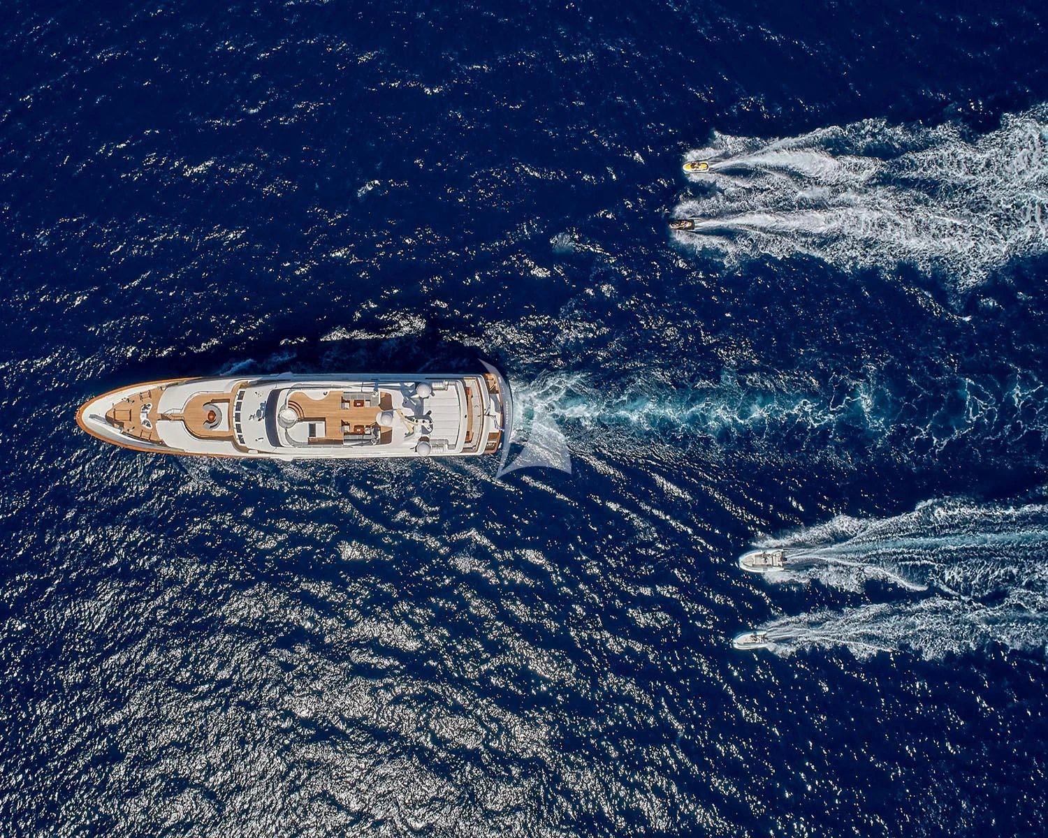a bottle of beer on a blue surface aboard ALEXANDRA Yacht for Charter