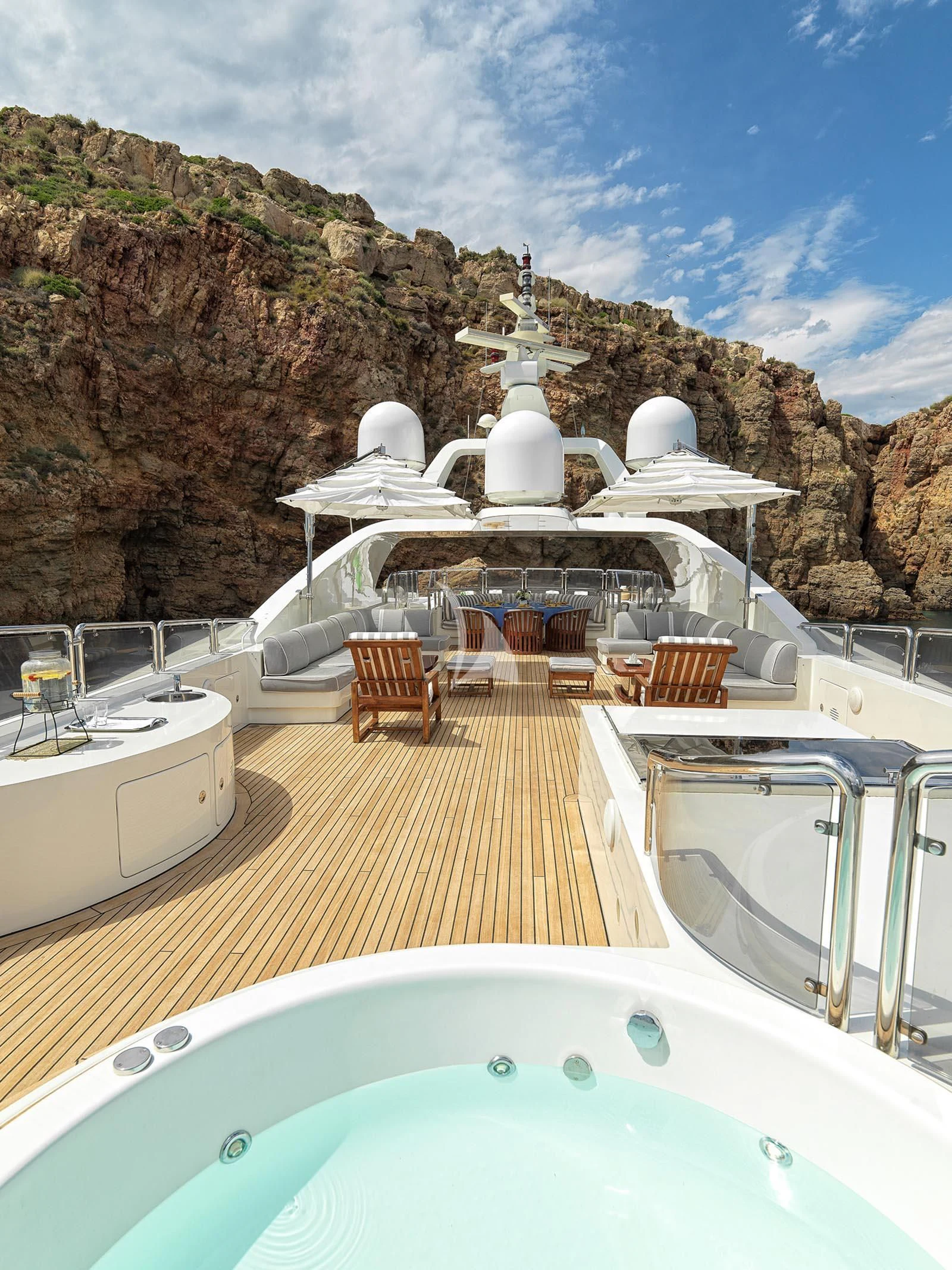 a swimming pool with a large rock cliff behind it aboard ALEXANDRA Yacht for Charter