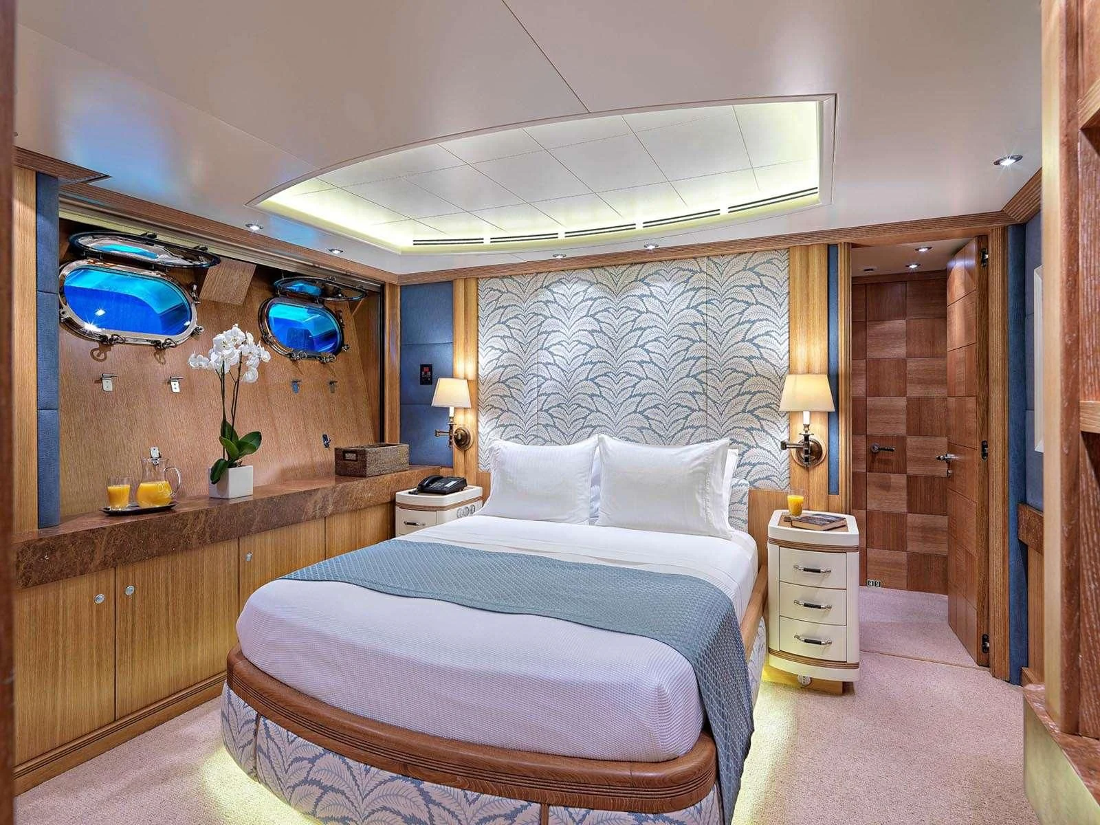 a room with a bed and a mirror aboard ALEXANDRA Yacht for Charter