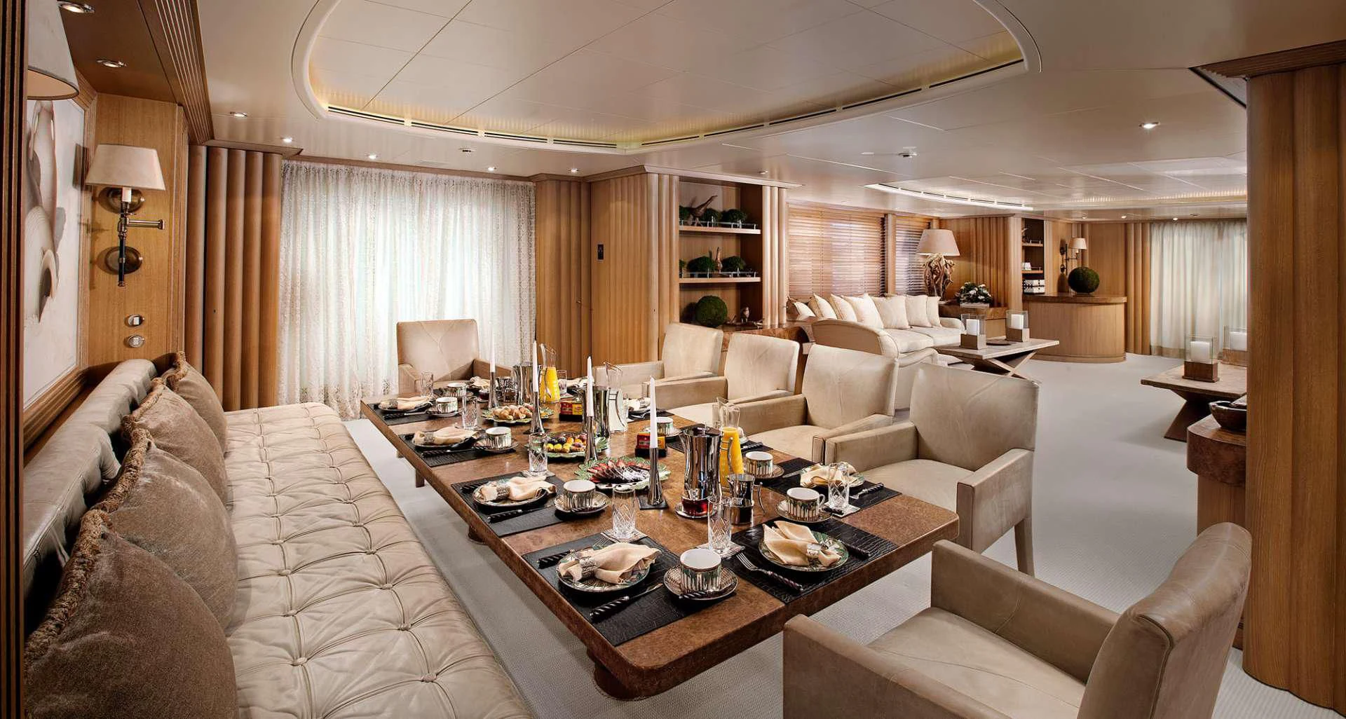 a living room with a table and couches aboard ALEXANDRA Yacht for Charter