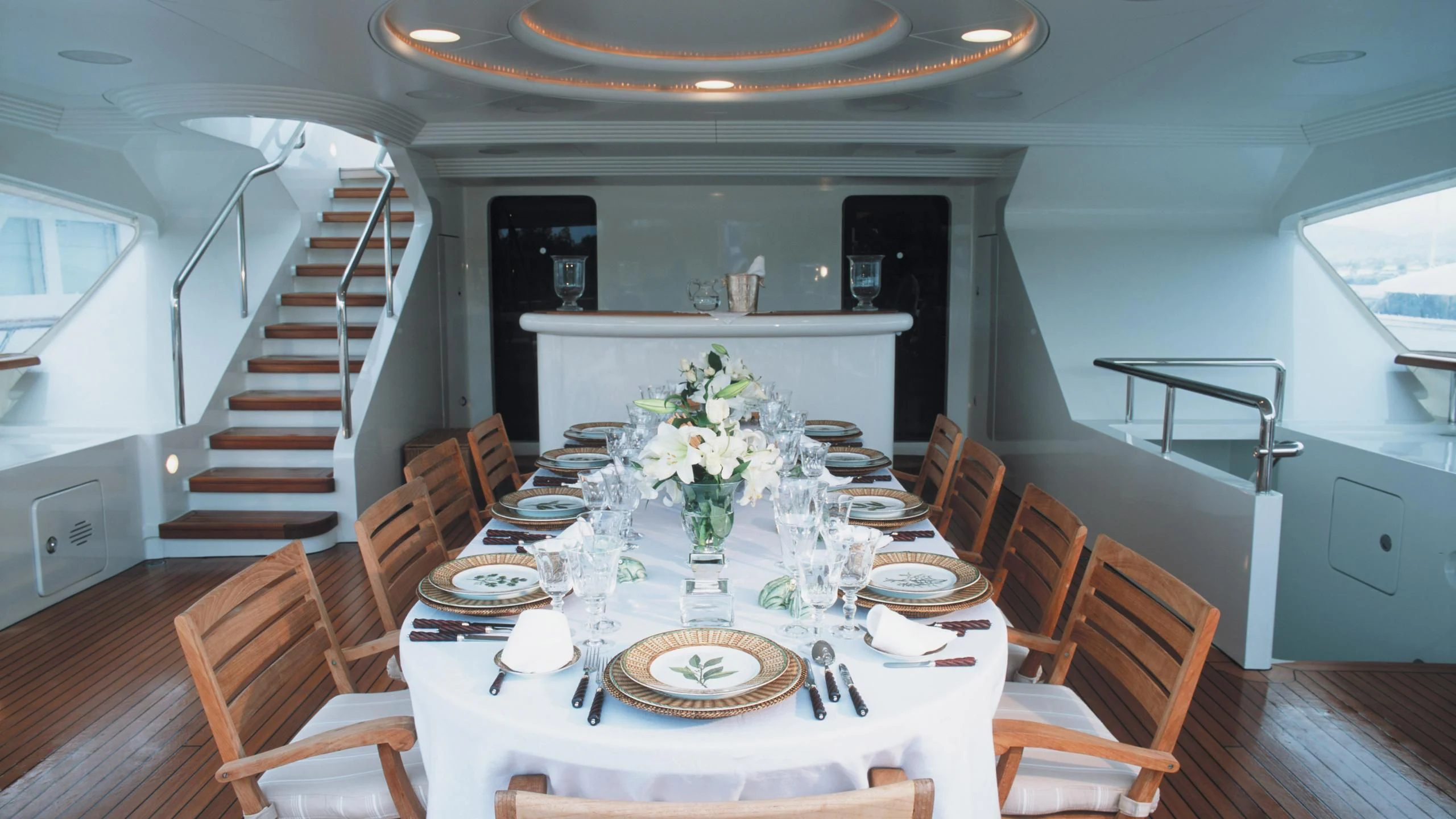 a dining room with a set of chairs and a staircase aboard ALEXANDRA Yacht for Charter