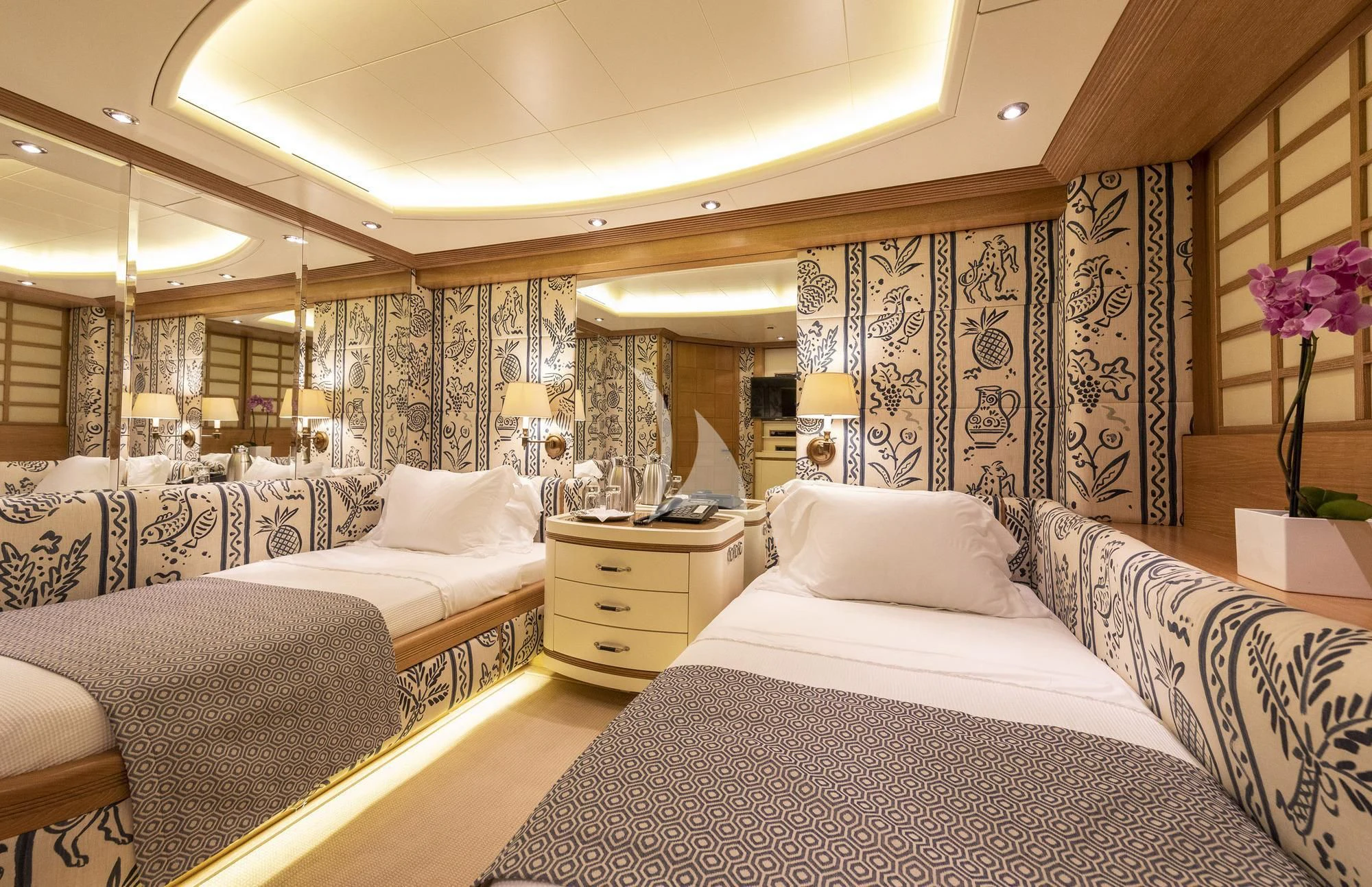 a room with beds and a lamp aboard ALEXANDRA Yacht for Charter