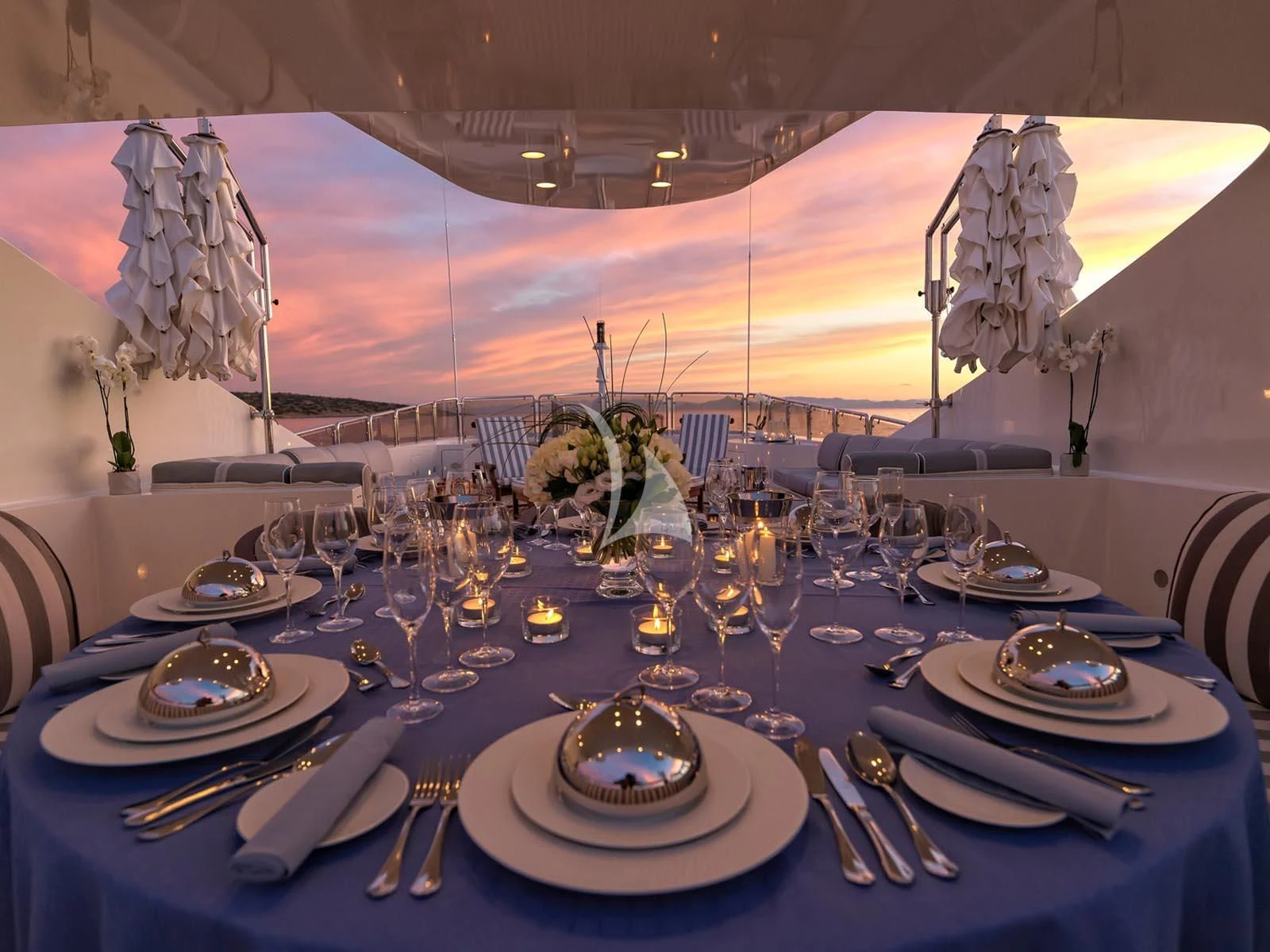 a table set with plates and silverware aboard ALEXANDRA Yacht for Charter