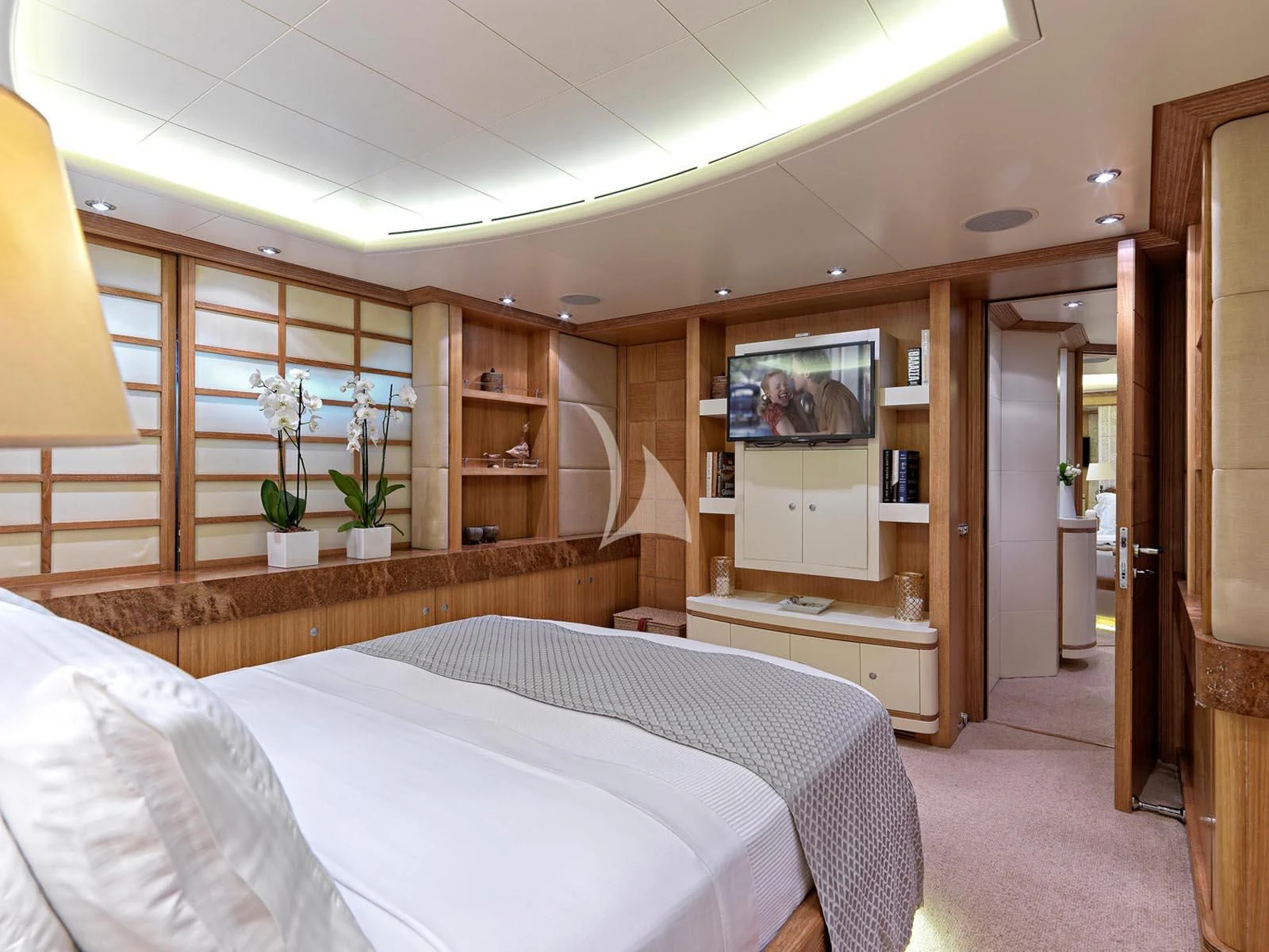 a room with a bed and a television aboard ALEXANDRA Yacht for Charter