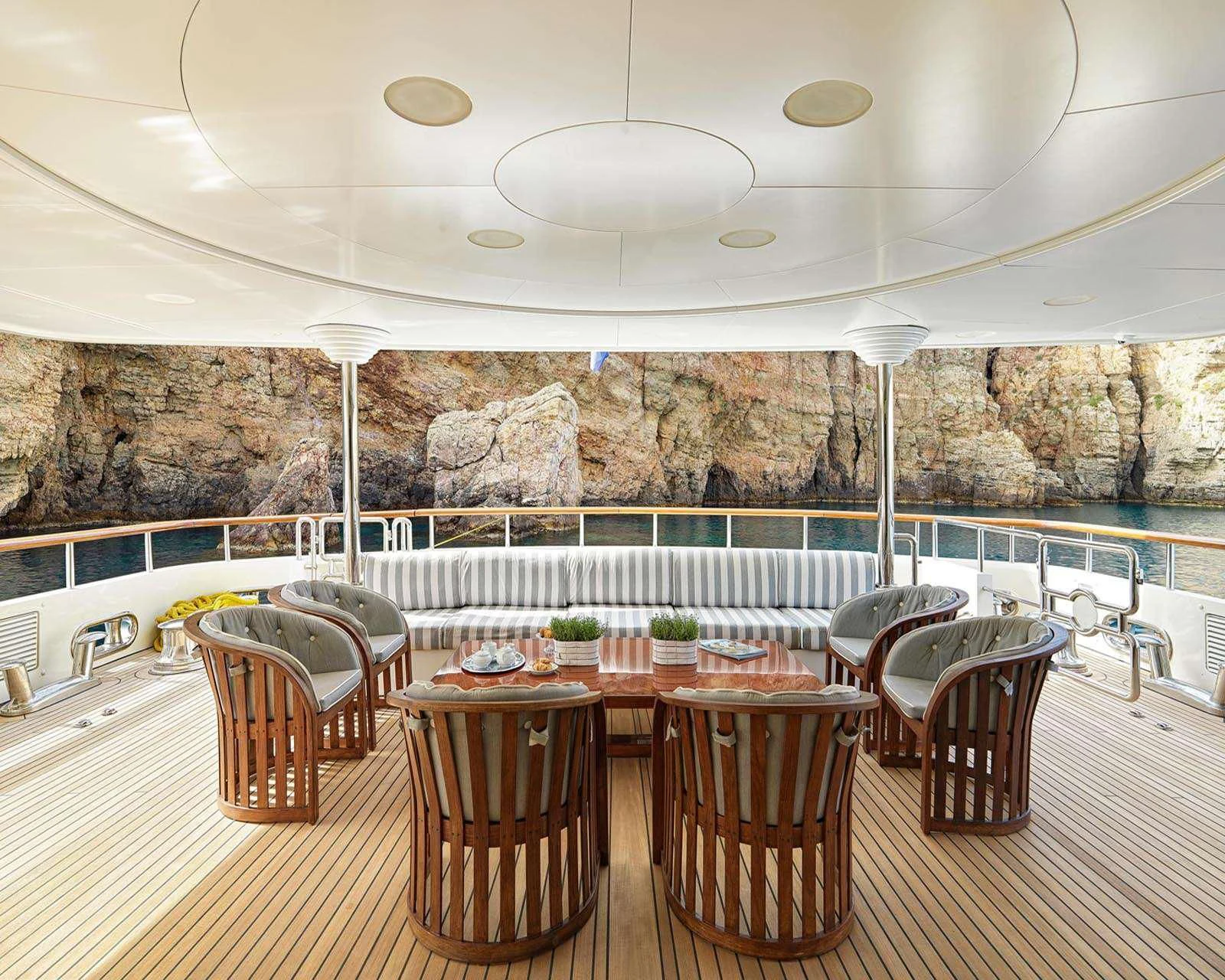 a room with tables and chairs aboard ALEXANDRA Yacht for Charter