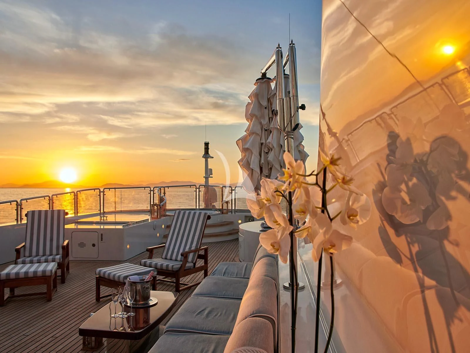 a balcony with a view of the sunset and a large building with a dome and a large dome aboard ALEXANDRA Yacht for Charter