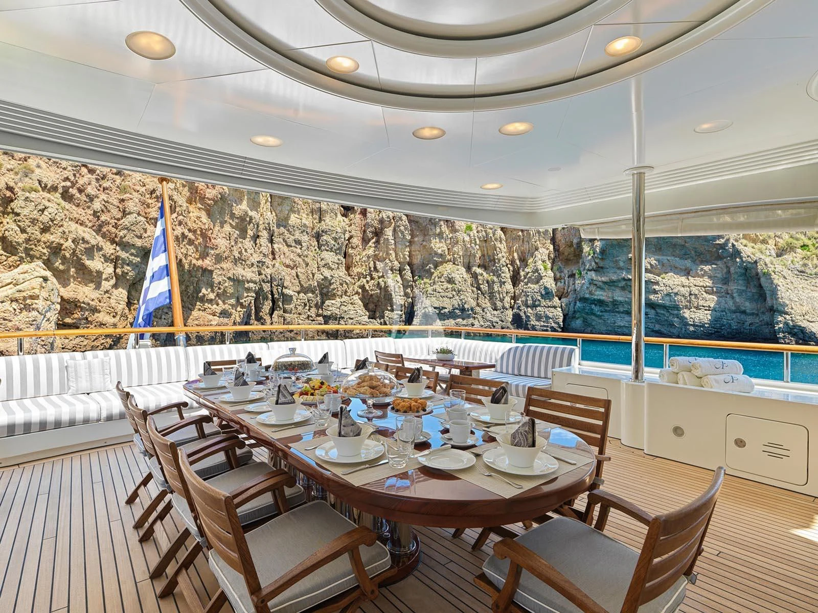 a dining table on a deck aboard ALEXANDRA Yacht for Charter