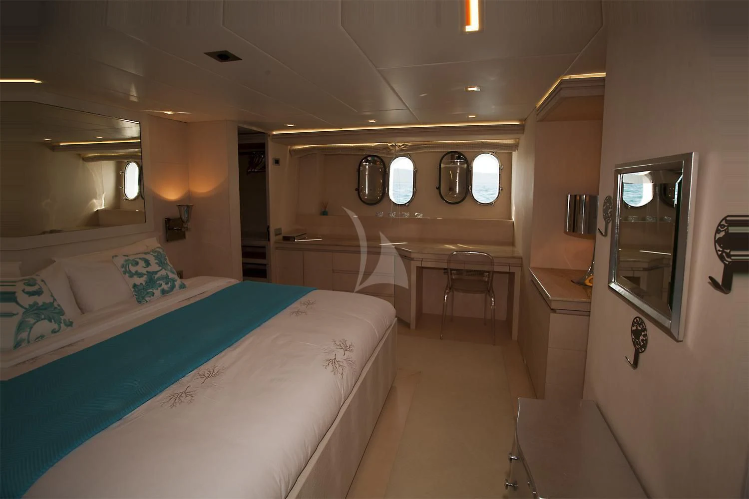 a room with a bed and a table aboard TUSCAN SUN Yacht for Charter
