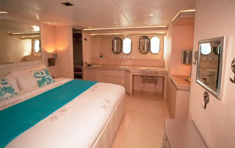 a room with a bed and a table aboard TUSCAN SUN Yacht for Charter