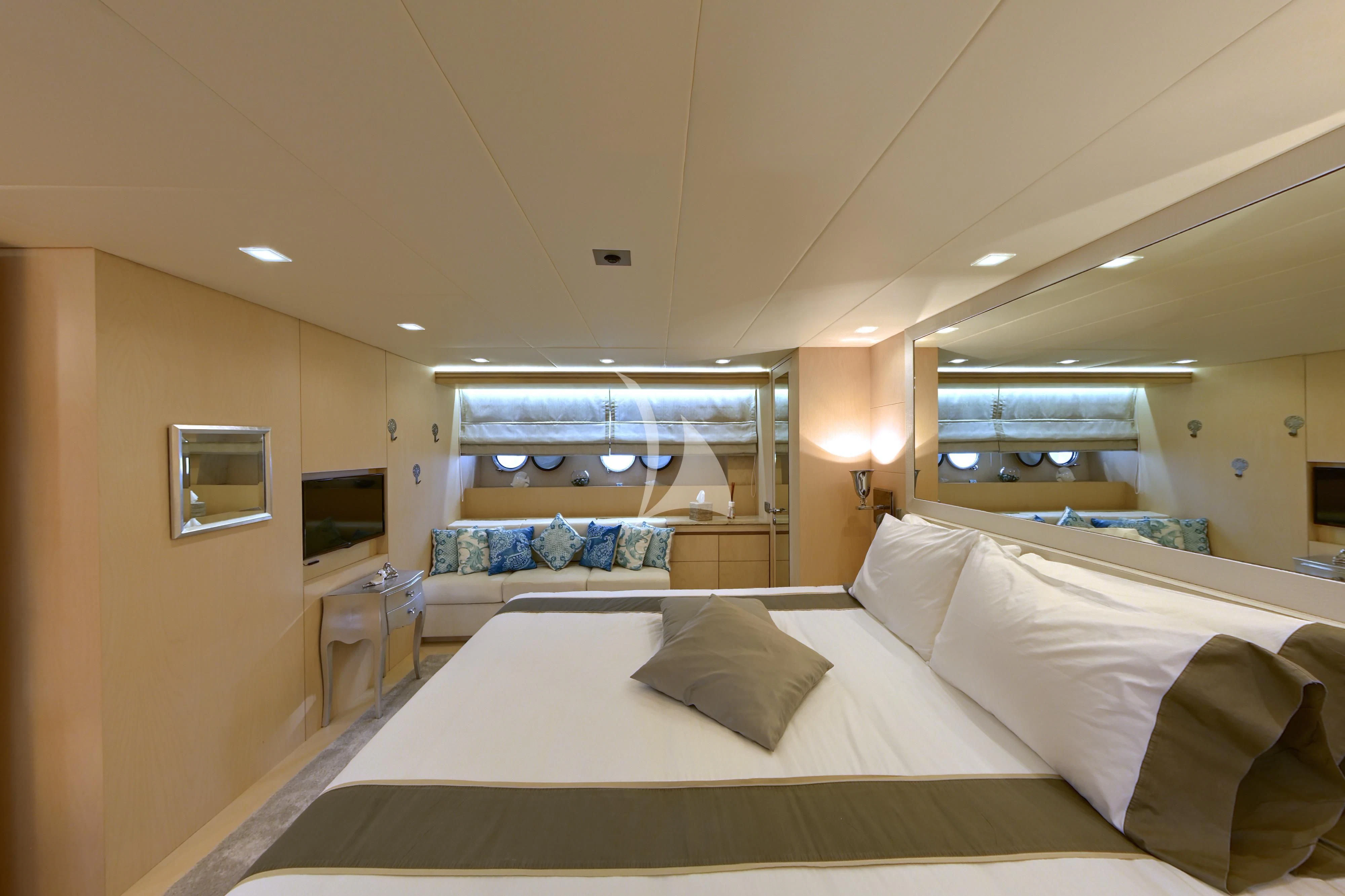 a room with a bed and a mirror aboard TUSCAN SUN Yacht for Charter