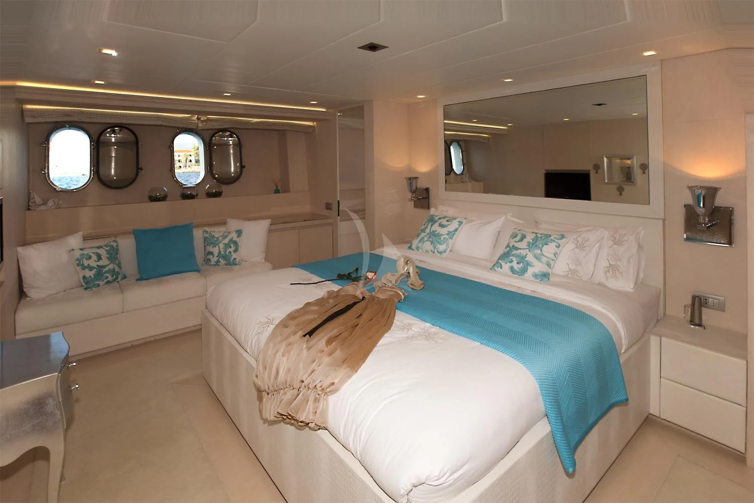 a room with a bed and a mirror aboard TUSCAN SUN Yacht for Charter